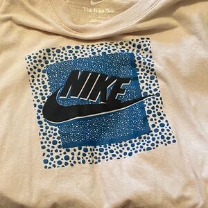 Nike Tee in Light Pink with Blue Graphic and Black Swoosh